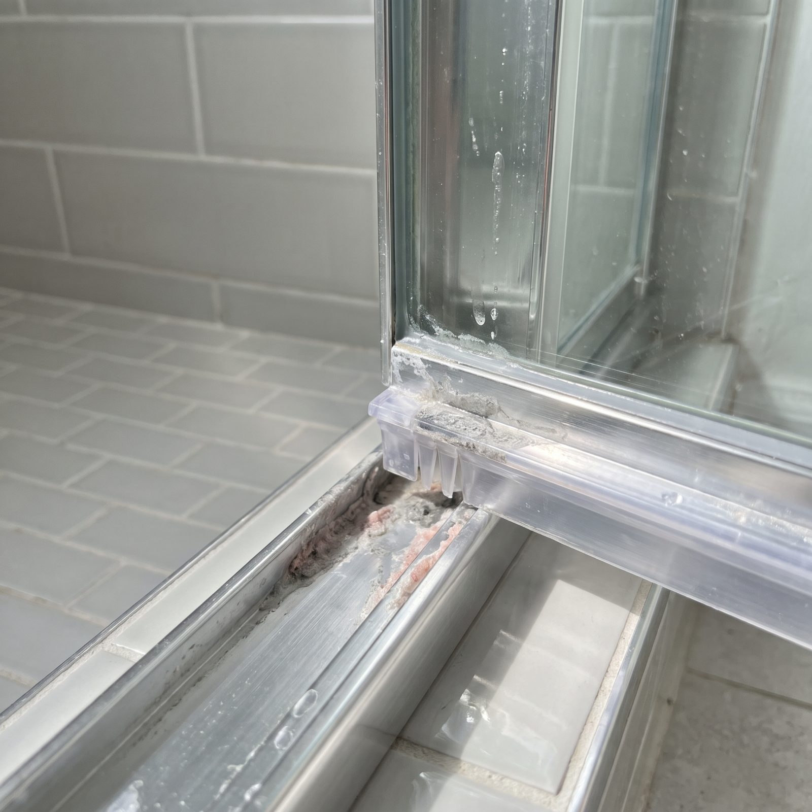 The Shower Door Bottom Seal and Its Hidden Soap-Scum Channel